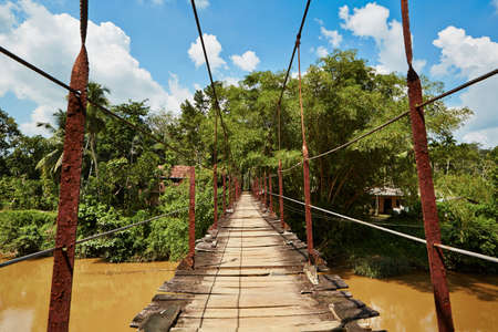 Old suspension bridge in mountain in Sri Lanka.の写真素材