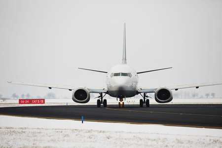 Airplane is taxiing on the airport in winter 