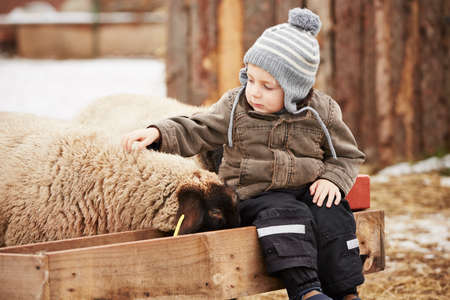 Little boy on the farm in winterの写真素材
