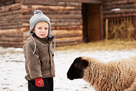 Little boy on the farm in winterの写真素材