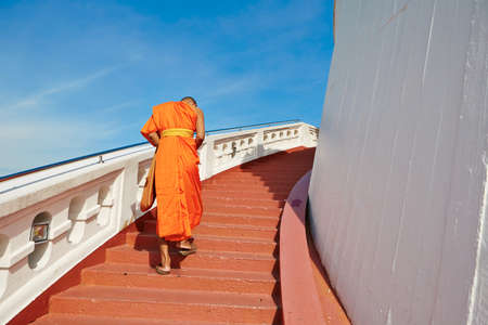Monk is walking to the temple Wat Saket (Golden mountain) in Bangkokの写真素材