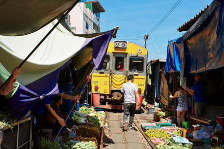 MAEKLONG, THAILAND - MAY 21  Railway market on May 21, 2014 in Maeklong, Thailand  Train passing through local market is popular tourist attraction 80 km far from Bangkok のeditorial素材
