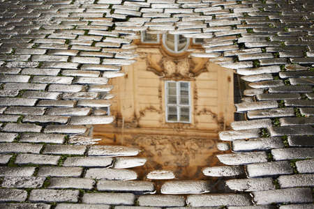 After rain in Prague - reflection of the house in puddleの写真素材