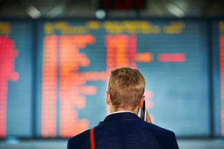Young businessman is waiting at the airportの写真素材
