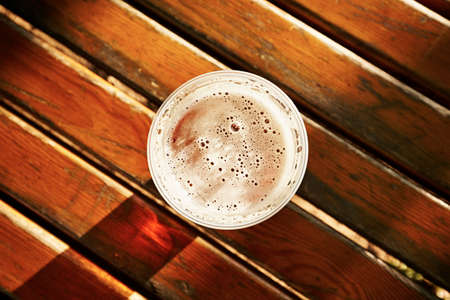 Cup of beer in garden restaurantの写真素材