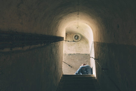 Sad man is crying in dark underground