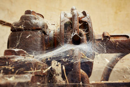 Cog wheel with cobweb in abandoned factoryの写真素材