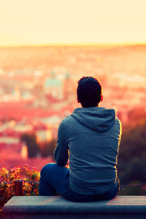 Young man is looking at the sunrise.の写真素材