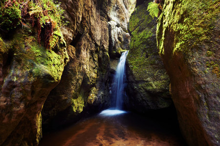 Long exposure photography of waterfall among rock wallsの写真素材