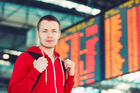 Portrait of the handsome young traveler at the airportの写真素材