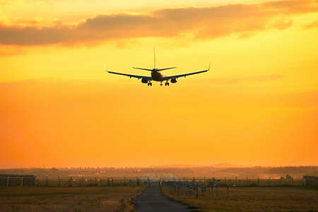 Silhouette of the airplane during landing at the airportの写真素材