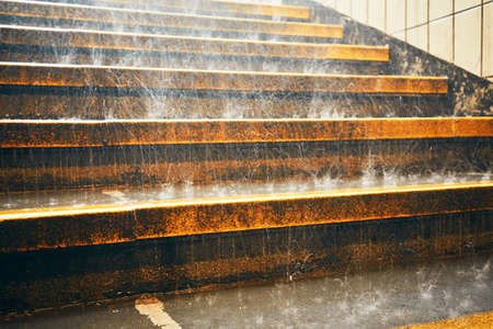 Heavy rain in the city. Rain droplets on the staircase during downpour.の写真素材