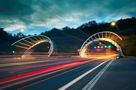 Traffic at night. Lights of the cars and trucks on the highway to the tunnel. Prague, Czech Republic