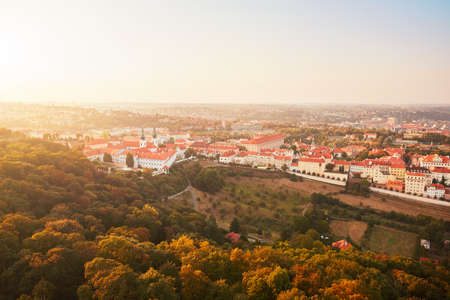 Skyline of historical part of Prague Capital. Strahov Monastery and park under Petrin hill at the amazing sunset.の写真素材