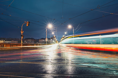 Light trails on the crossroad during rainy night in the city. Prague, Czech Republic.の写真素材
