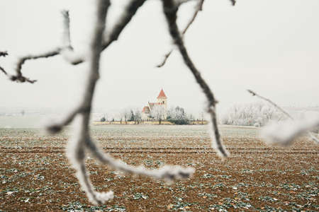 Small cemetery with a church amid frozen landscape, Czech Republicの写真素材