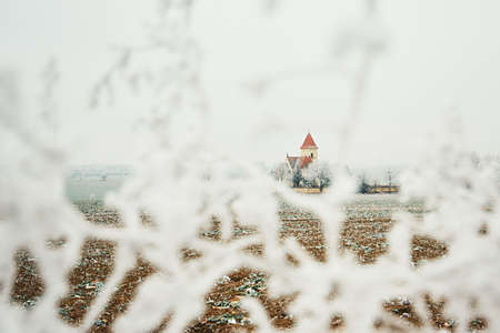 Small cemetery with a church amid frozen landscape, Czech Republicの写真素材