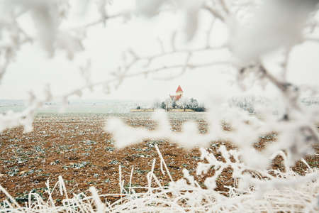 Small cemetery with a church amid frozen landscape, Czech Republicの写真素材