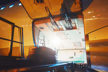 Preparation before flight. The baggage on the conveyor belt to the airplane.の写真素材