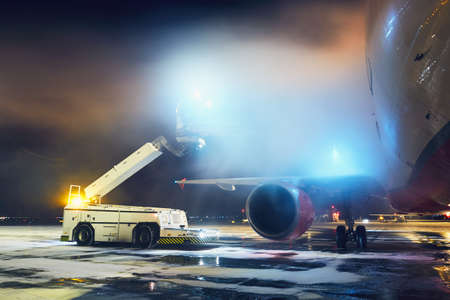 Airport in winter. Deicing of the airplane before flight.のeditorial素材