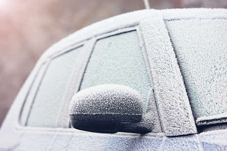 Car on the street covered by icing - selective focusの写真素材