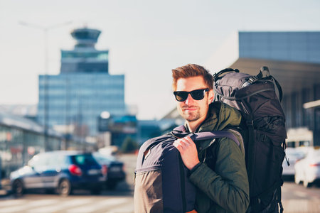 Portrait of the young traveler with backpack at the airport. Prague, Czech Republic.の写真素材