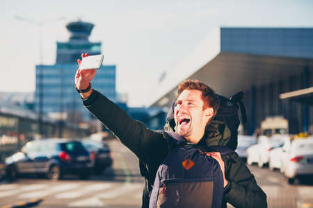 Traveler taking a selfie at the airport. Prague, Czech Republic.の写真素材