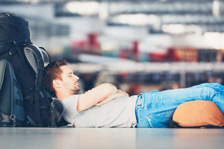 Traveler waiting at the airport departure area for his delay flight.の写真素材