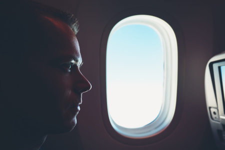Comfortable traveling by airplane. Silhouette of the passenger enjoying his journey inside an...