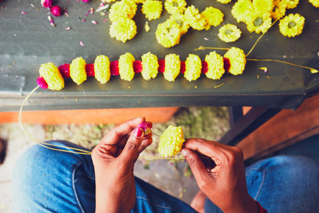 Flower seller preparation garlands for hindu religious ceremony - Kuala Lumpur, Malaysia - selective focusの写真素材