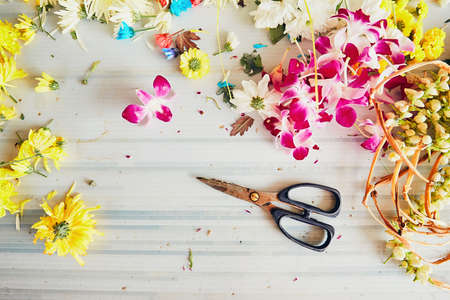 Scissors on the table in flower shop - making flower garlands for hindu religious ceremony の写真素材