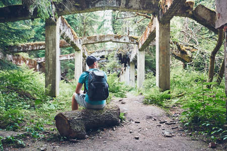 Young explorer inside of the abandoned old ruined factory in the middle of the forest. Ore mountains, Czech Republicの写真素材
