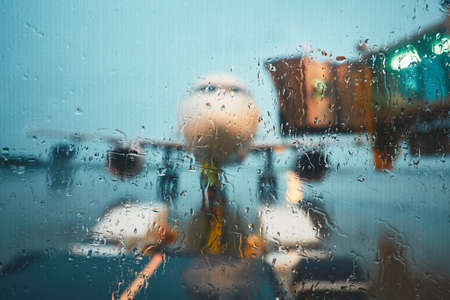 A busy airport in the rain. Push back of the airplane before flight.の写真素材