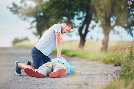 Dramatic resuscitation on the rural road. Themes rescue, help and hope.の写真素材
