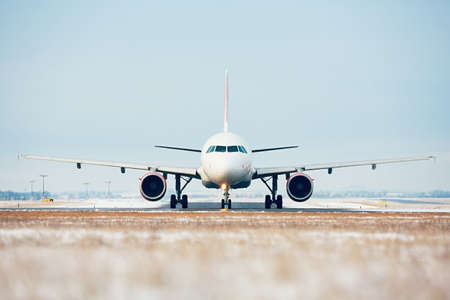 Airport in winter. Airplane taxiing to the runway for take off.の写真素材