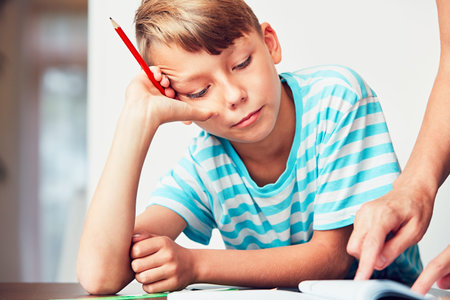 Little boy writing his homework for elementary school.