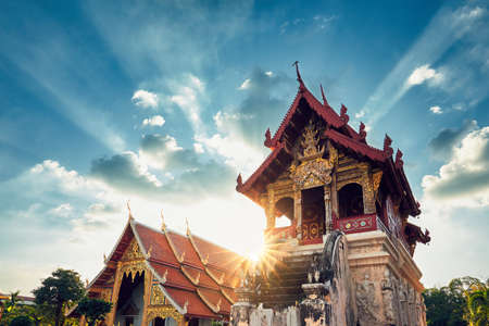 Buddhist Phra Singh Temple at amazing sunset. Tourists favorite landmark in Chiang Mai city centre, Thailand.の写真素材