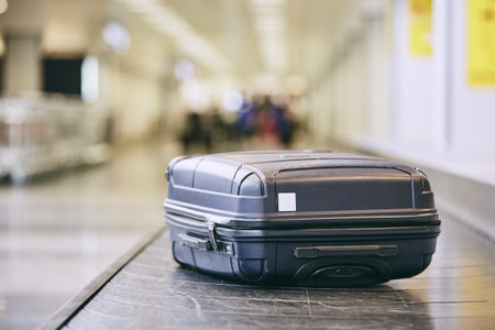Traveling by airplane. Suitcase on baggage claim in airport terminal.