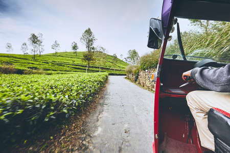 Tuk tuk taxi on the road through tea plantations in Sri Lanka.の写真素材