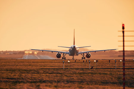 Airplane is on runway ready for take off. Traffic at airpot at sunset.の写真素材