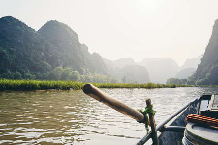 Rowboat against karst formation near Tam Coc in Ninh Binh province, Vietnam. Themes travel, relaxation and vacations.の写真素材