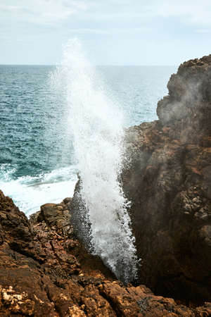 Water geyser from rock. Blow hole Hummanaya near Tangalle in Sri Lanka.の写真素材