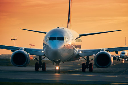 Traffic at airport. Airplanes in row taxiing to runway for take off. のeditorial素材