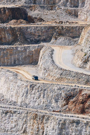 Industrial stone mining. Truck in the middle of huge quarry. の写真素材