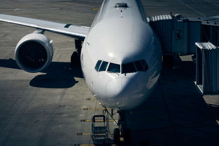 Front view od airplane at airport in drmatic light. Preparation passenger plane before flight.の写真素材