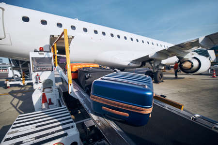Preparation before flight. Loading of luggage to airplane at airport.の写真素材