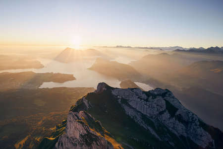 Scenic view of lake and mountains against beautiful sunrise. Lucerne, Switzerland.の写真素材