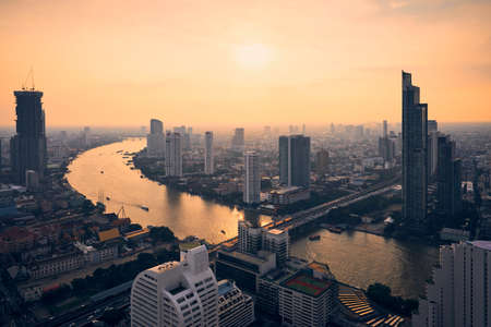 Urban skyline Bangkok during sunset. Skyscrapers near Chao Phraya river, Thailand.の写真素材