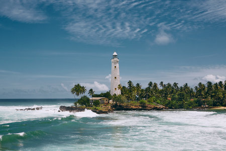 Lighthouse in the middle of palm trees. South coast of Sri Lanka during beautiful sunny day.の写真素材