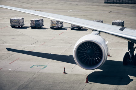 Loading of cargo containers to plane at airport. Ground handling preparing airplane before flight...